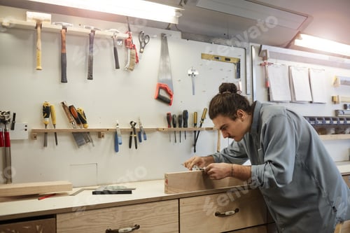 Preview: Repairman working with wood