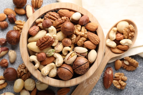Preview: Mix of different nuts on grey table, flat lay