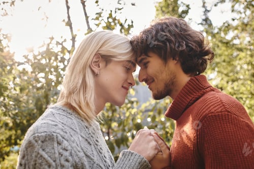 Preview: Joyful moments shared between two young men in an autumn park setting