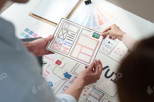 Preview: UXUI design review with sketches and digital tools on table