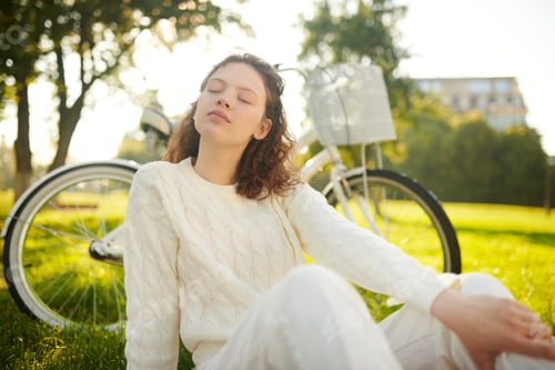 Preview: A girl sitting with her eyes closed and looking relaxed