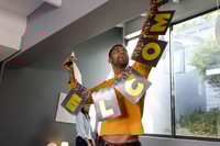 Preview: Man Decorating for Party with Woman Nearby