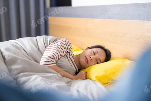 Preview: Peaceful young woman sleeping on cozy bed