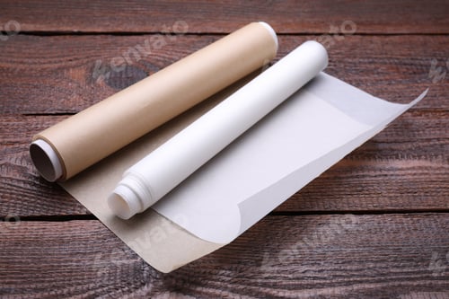 Preview: Rolls of baking paper on wooden table