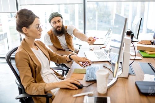 Preview: Creative man and woman working in the office