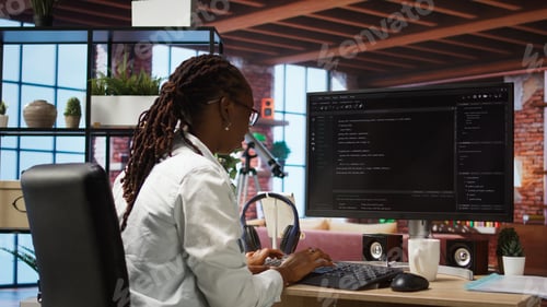 Preview: Close up of person using coding application to write and test code