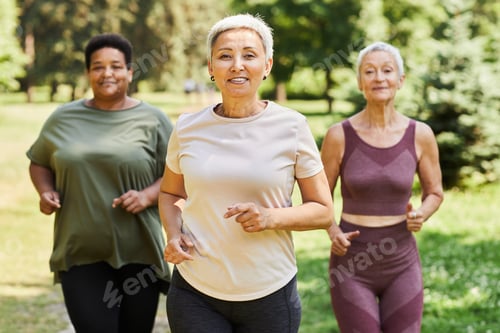 Preview: Active senior women running towards camera outdoors and enjoying sports