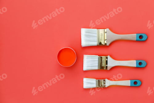 Preview: Paint can and brush on orange background.