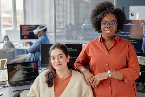 Preview: Female Software Developers Facing Camera at Workplace