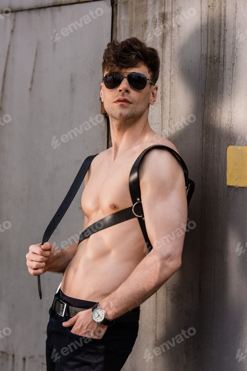 Preview: sexy shirtless man in black sunglasses and sword belt with hand in pocket