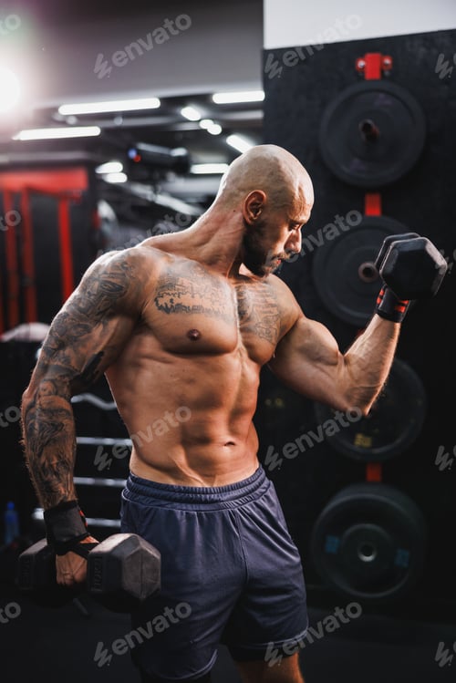 Preview: Man Exercise With Weights And Showing His Muscles At The Gym