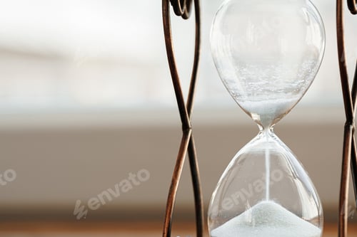 Preview: Sandglass on wooden bakground closeup. Time concept