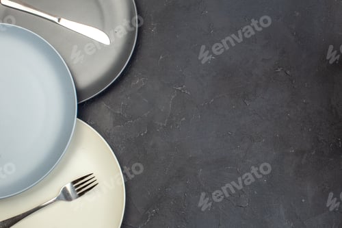 Preview: top view colored plates on dark background glass meal kitchen cutlery food ceramic table colors free