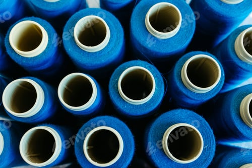 Preview: A closeup shot of blue spools of thread