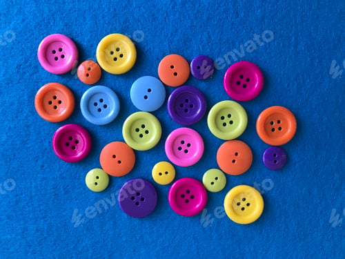Preview: Looking down on a variety of vibrant and various size of buttons placed in a abstract design!
