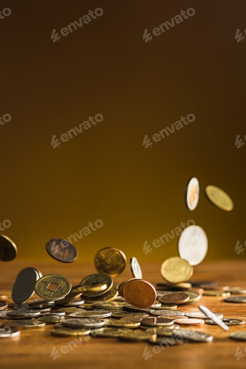 Preview: The silver and golden coins and falling coins on wooden background
