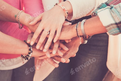 Preview: Teamwork and friendship together concept with hands put on hands - women power day
