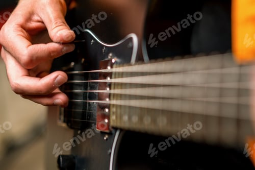 Preview: rock performer with electric guitar in recording studio recording playing track