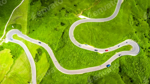 Preview: Cars driving on winding road in the dolomites, aerial view