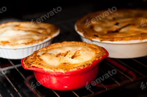 Preview: three apple pies cooking in the oven