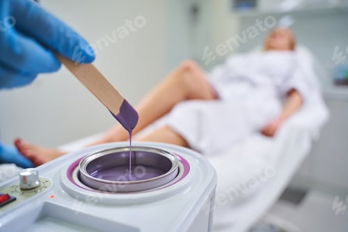 Preview: Close up of cosmetologist that heating wax