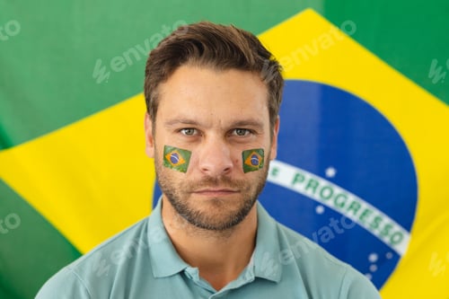 Preview: Image of happy caucasian man with flags of brazil on face over flag of brazil