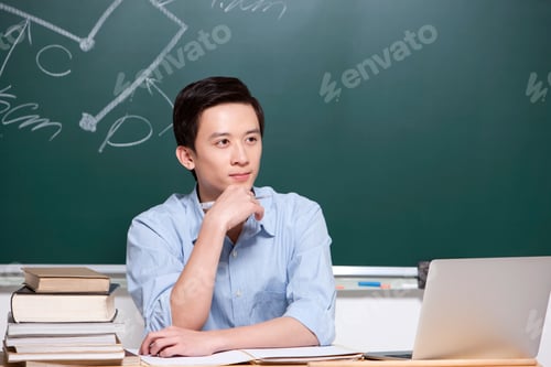 Preview: Serious male teacher hand on chin in classroom