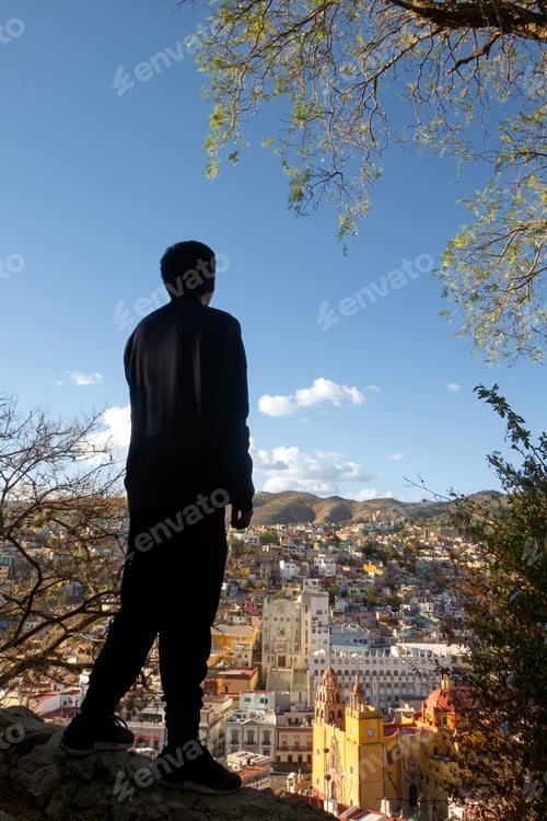 Preview: A man enjoying the vibrant cityscape of Guanajuato, Mexico, surrounded by nature iconic landmarks