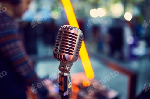 Preview: Close up of a professional vintage microphone with blurred lights in the background