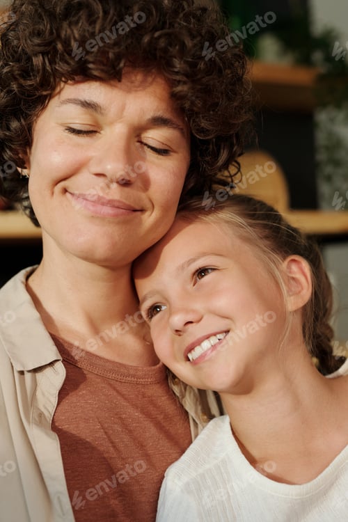 Preview: Young serene woman with her eyes closed and cute youthful girl with toothy smile