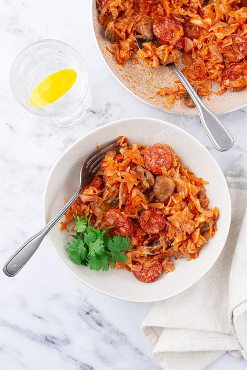 Preview: Bigos, Polish dish bigos, on the table, pan with stewed meat, with cabbage, chorizo sausages,