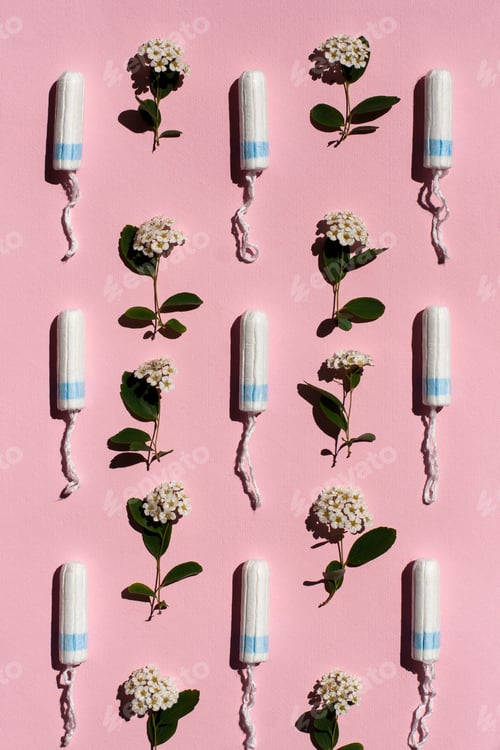Preview: Medical female tampon and white flowers on a pink background.