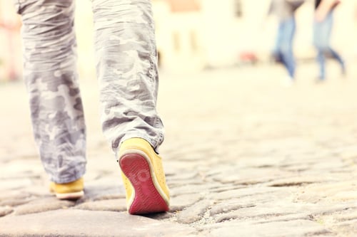 Preview: Female legs on paving blocks