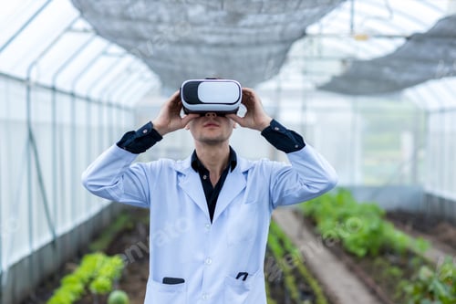 Preview: scientist in virtual reality glasses playing the game. scientist with vr headset in garden, concept