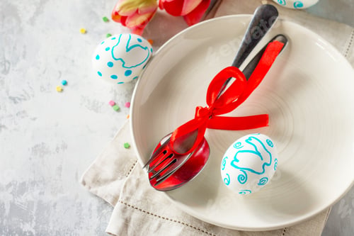Preview: Easter table setting with tulips flowers, Easter eggs and cutlery.