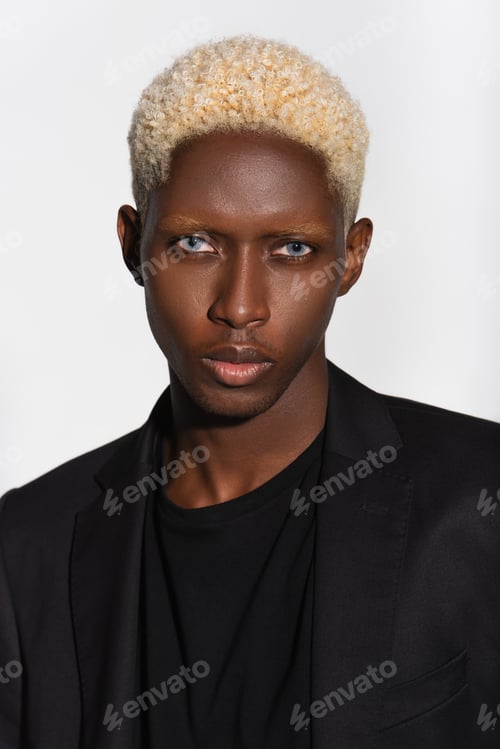 Preview: portrait of blonde african american man looking at camera isolated on grey