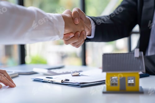 Preview: The estate agent and client are shaking hands after a good deal home loan after discussing and signi