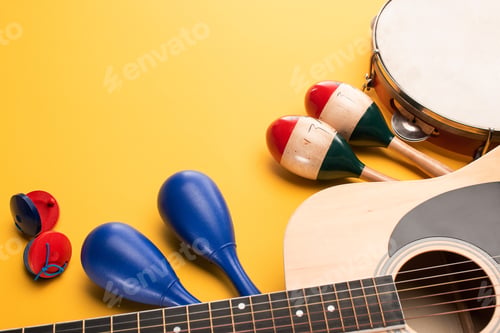 Preview: Wooden colorful and blue maracas with tambourine, castanets and acoustic guitar on yellow background