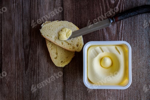 Preview: Creamy butter spread on slice of bread.