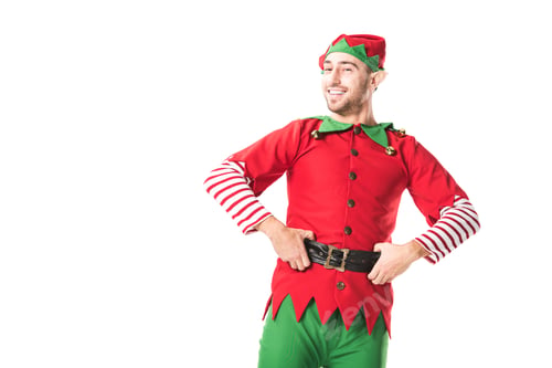 Preview: cheerful man in christmas elf costume looking at camera with hands on hips isolated on white