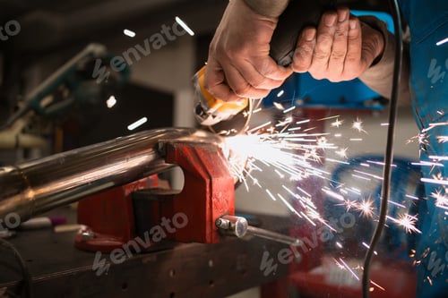 Preview: Worker working with a circular grinder on a metal with sparks
