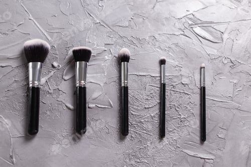 Preview: Top view of make-up brushes on grey background