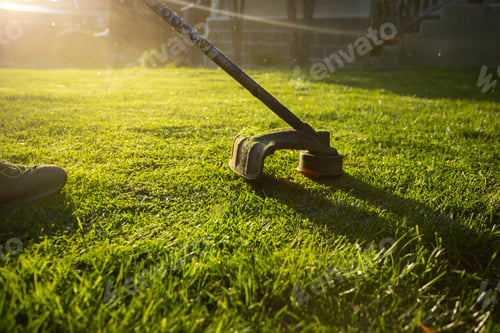Preview: Garden worker with lawn mover. Garden works in spring.