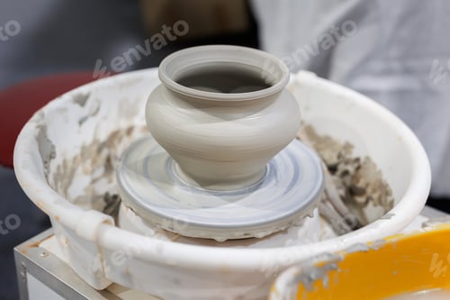 Preview: Close-up of a clay pot on a potter's wheel at a farmers' fair.