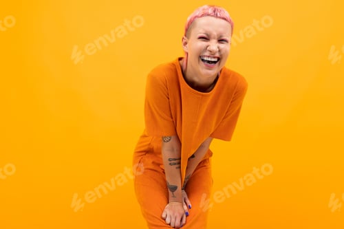 Preview: girl with pink hair and a pierced face dressed in a loose orange dress on a yellow background