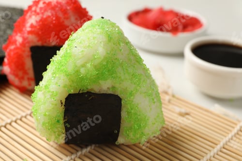 Preview: Tasty tobiko onigiri (Japanese rice balls) served on light table, closeup