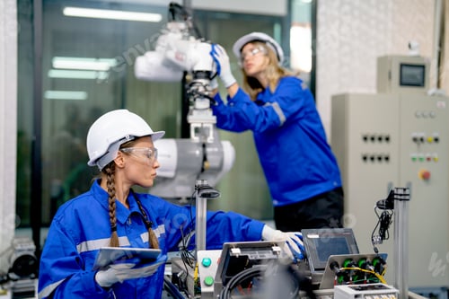Preview: Two professional engineers or technician worker women help to check and maintenance robot