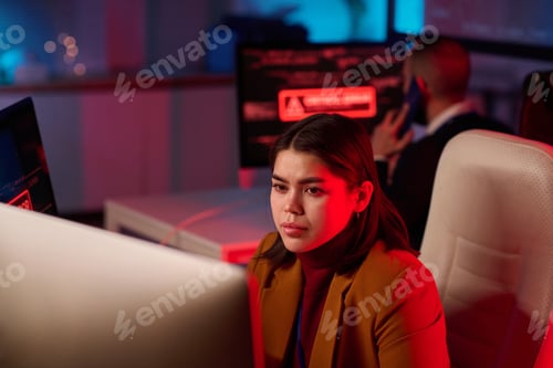 Preview: Girl using Computer in IT Office with Red Light