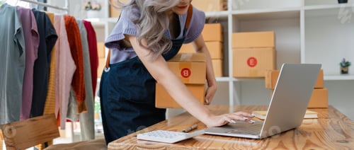 Preview: Woman sell clothes online with laptop and parcels in office. Online store