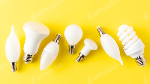 Preview: top view of various types of light bulbs on yellow